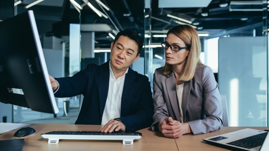 team members studying information on computer