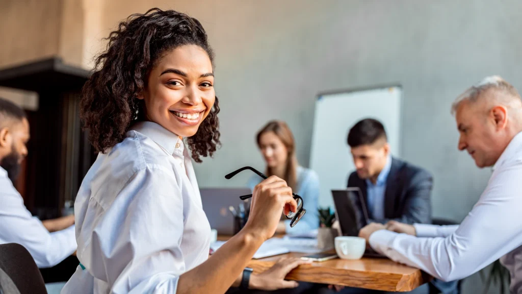 people working in office and woman smiling